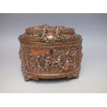 A CAST METAL OVAL CASKET WITH RELIEF FIGURAL DECORATION, the hinged lid and panels depicting