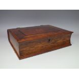 AN ANTIQUE OAK AND MAHOGANY WRITING SLOPE IN THE FORM OF A BOOK, the hinged lid opening to reveal