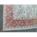 AN EASTERN WOOLLEN 20TH CENTURY RUG / CARPET, all over floral pattern on a mainly beige ground,