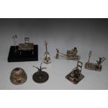A COLLECTION OF SEVEN NOVELTY MINIATURES, to include hallmarked, 925 and unmarked examples, desk W 8