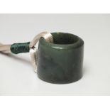 A CHINESE SPINACH JADE ARCHERS RING / THUMB GUARD, of plain form, H 2.7 cm, overall Dia. 3.1 cm,