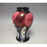 A MOORCROFT 'BELLAHOUSTON' PATTERN VASE, depicting stylised roses on a black ground, designed by