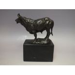 A 20TH CENTURY BRONZE SCULPTURE OF A BULL, raised on a marble plinth, signed Milo and having