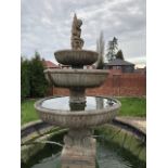 A LARGE STONE GRADUATED THREE TIER WATER FOUNTAIN, early 20th century with a cherub surmount above