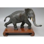 A BRONZE TYPE MODEL OF A WALKING ELEPHANT, W 20 cm