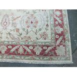 AN EASTERN WOOLLEN 20TH CENTURY RUG / CARPET, all over floral pattern on a mainly beige ground,