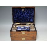 A 19TH CENTURY ROSEWOOD FITTED DRESSING BOX, the hinged lid opening to reveal a fitted interior with