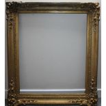 A 19TH CENTURY GOLD FRAME WITH SWEPT CORNERS, rebate size 77 x 64 cm, width of frame 10 cm