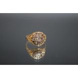 A HALLMARKED 18 CARAT GOLD OLD CUT DIAMOND CLUSTER RING, the central diamond being oval and