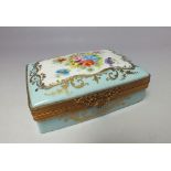 A LATE 19TH / EARLY 20TH CENTURY LIMOGES TRINKET BOX, with painted floral decoration and gilded