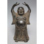 A CHINESE STYLE STANDING BUDAI WITH RAISED ARMS, H 17.5 cm