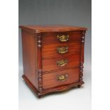 A DESK TOP CHEST OF FOUR DRAWS, H 35.25 cm