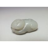 A CHINESE CELADON PENDANT OF A RECUMBENT CAT, finely carved detail, L 4.2 cm, W 3.2 cm