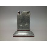 A STYLISH ART DECO CHROME TABLE LIGHTER, having engraved decoration depicting French style dancing