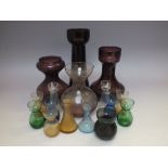 THREE VICTORIAN AUBERGINE GLASS HYACINTH VASES, tallest H 23 cm, together with another glass