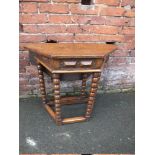 AN ANTIQUE STYLE OAK DROPLEAF TABLE, the octagonal top raised on bobbin turned supports, H 73 cm,
