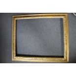 A LATE 18TH / EARLY 19TH CENTURY REVERSE MOULDING GOLD FRAME, inset panels with floral