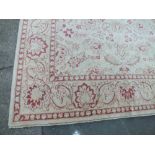 A LARGE EASTERN 20TH CENTURY WOOLLEN RUG, cream ground, red / yellow floral pattern, 360 x 276 cm