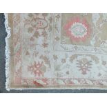AN EASTERN WOOLLEN 20TH CENTURY RUG / CARPET, the all over floral pattern on a mainly beige /