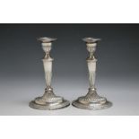 A PAIR OF HALLMARKED SILVER CANDLE STICKS BY THOMAS BARDBURY & SONS - LONDON 1884, having filled