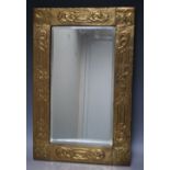 AN ARTS AND CRAFTS BRASS FRAMED BEVELLED MIRROR, mirror 44 x 23 cm, frame 57 x 37 cm