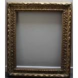 A 19TH CENTURY DECORATIVE GOLD PORTRAIT FRAME, rebate 77 x 64 cm, width of frame 14 cm