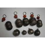 A COLLECTION OF NINE CHINESE METAL BABIES' BELLS, some having agate bead decoration, largest H 9 cm