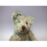 A VINTAGE BLUE MOHAIR JOINTED BEAR, possibly a Farnell example, H 30.5 cm A/F ConditionReport:With