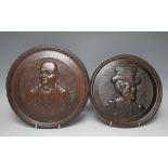 A PAIR OF CARVED OAK ROUNDS, featuring Dickens characters Sam Weller and Micawber, Dia 28 cm