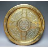 AN ISLAMIC BRASS AND SILVER TRAY, of circular form with calligraphy decoration of panels of