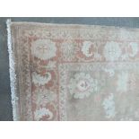 AN EASTERN 20TH CENTURY WOOLLEN RUG / CARPET, light brown floral pattern throughout, 284 x 212 cm