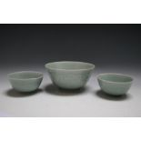 THREE CHINESE TYPE CELADON BOWLS, featuring Koi carp amongst the water lilies, largest Dia 16.25 cm