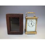 A VINTAGE BRASS CASED CARRIAGE CLOCK IN FITTED CASE, the brass case with five glass panels having