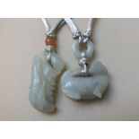 TWO JADE FIGURAL PENDANTS IN THE FORM OF MYTHICAL BEASTS, finely carved in shallow relief, one