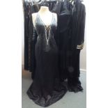 A SELECTION OF LADIES EVENING WEAR, comprising a selection of suits and dresses, mainly black,