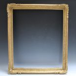 A 19TH CENTURY GOLD SWEPT FRAME WITH RUNNING PATTERN, frame W 6 cm, rebate 66 x 56 cm