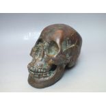 A VINTAGE PATINATED BRONZE SKULL, H 13 cm, L 19 cm