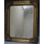 AN EARLY 19TH CENTURY BRASS FRAMED MIRROR, mirror site size 52 x 38 cm, thickness of frame 7 cm