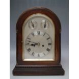 AN EARLY 20TH CENTURY MAHOGANY CASED MUSICAL MANTEL CLOCK, the silvered dial with Roman numerals,