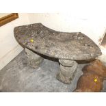 A SMALL STONE GARDEN BENCH