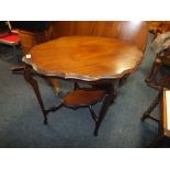 AN EDWARDIAN MAHOGANY SHAPED TWO TIER OCCASIONAL TABLE