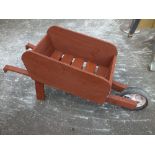 A WOODEN WHEELBARROW PLANTER