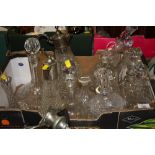 A TRAY OF CUT GLASS DECANTERS ETC