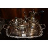 A SILVER PLATED FOUR PIECE TEA SERVICE ON TWIN HANDLED SERVING TRAY