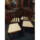 A SET OF FOUR OAK BARLEY TWIST DINING CHAIRS