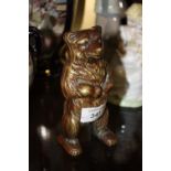 A VINTAGE BRASS BEAR SHAPED MONEY BANK