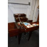 A VINTAGE MAHOGANY TYPE FOLD OUT SEWING BOX AND CONTENTS