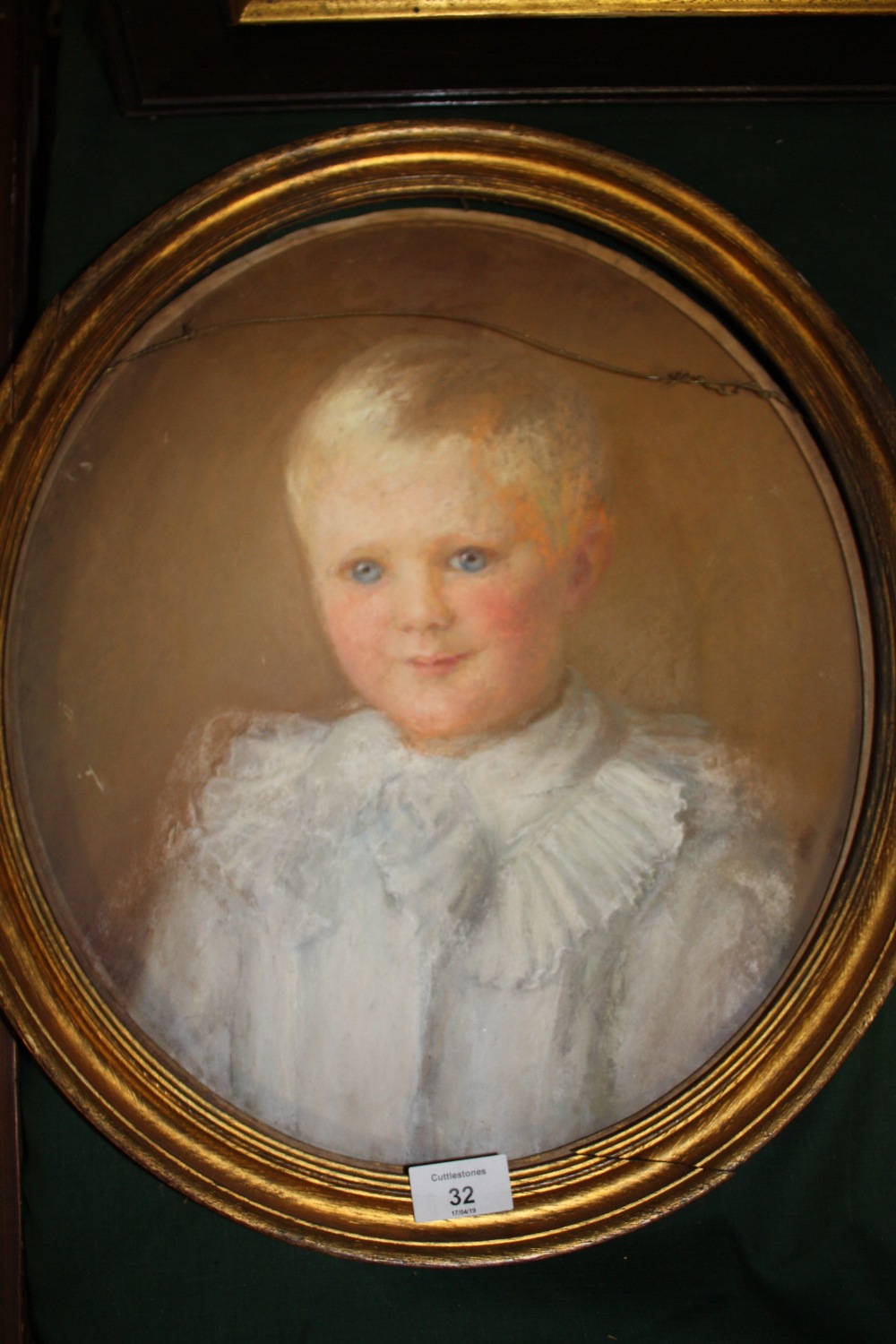 AN OVAL PASTEL PORTRAIT STUDY OF A YOUNG BOY IN CLASSICAL DRESS WITH GILT FRAME A/F