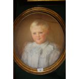 AN OVAL PASTEL PORTRAIT STUDY OF A YOUNG BOY IN CLASSICAL DRESS WITH GILT FRAME A/F