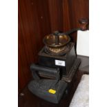 A VINTAGE TABLETOP GRINDER TOGETHER WITH A VINTAGE IRON WITH STAFFORDSHIRE KNOT DETAIL